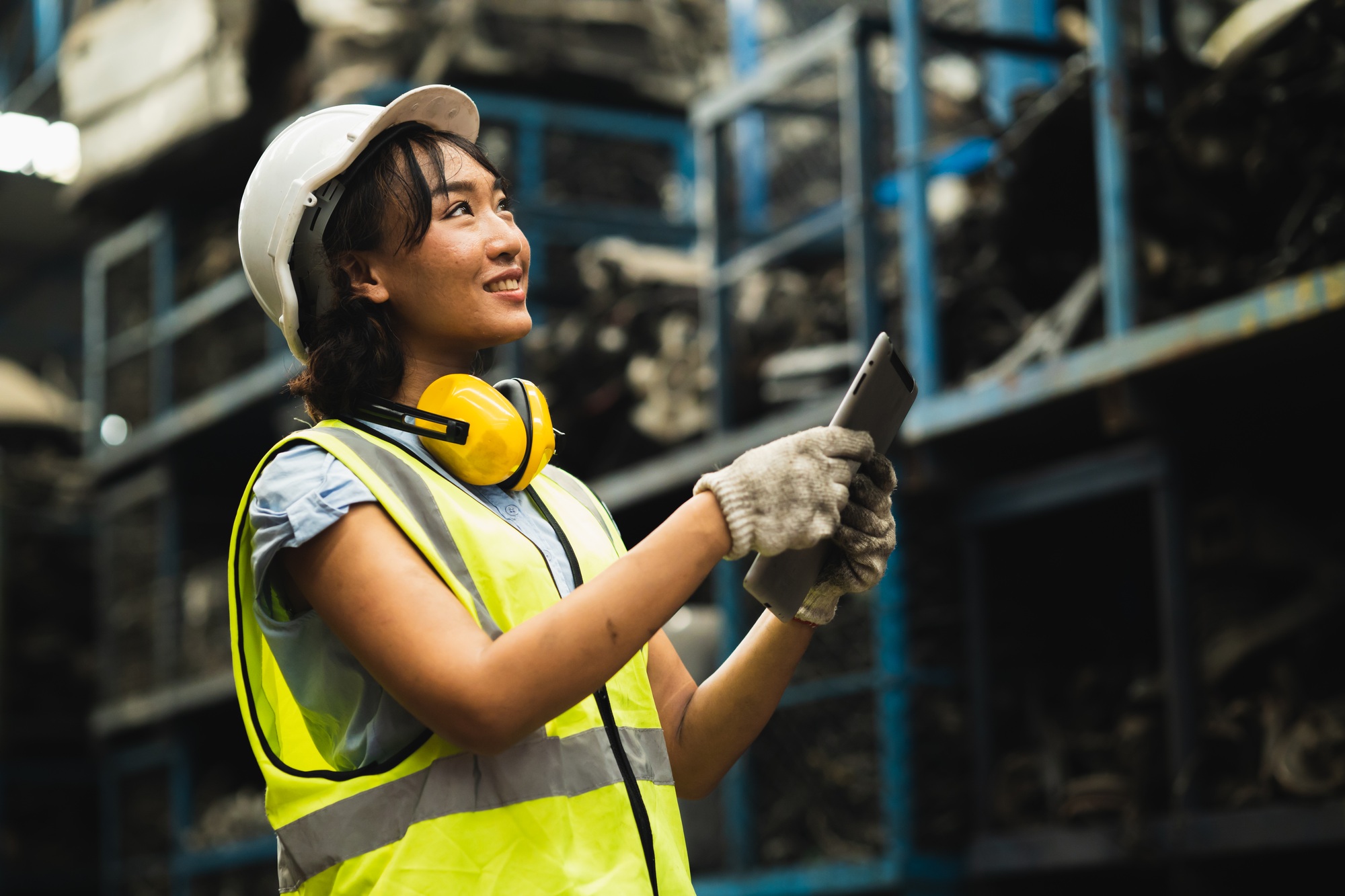 Happy women worker engineer technician employee working dirty workplace. Inventory manager staff in