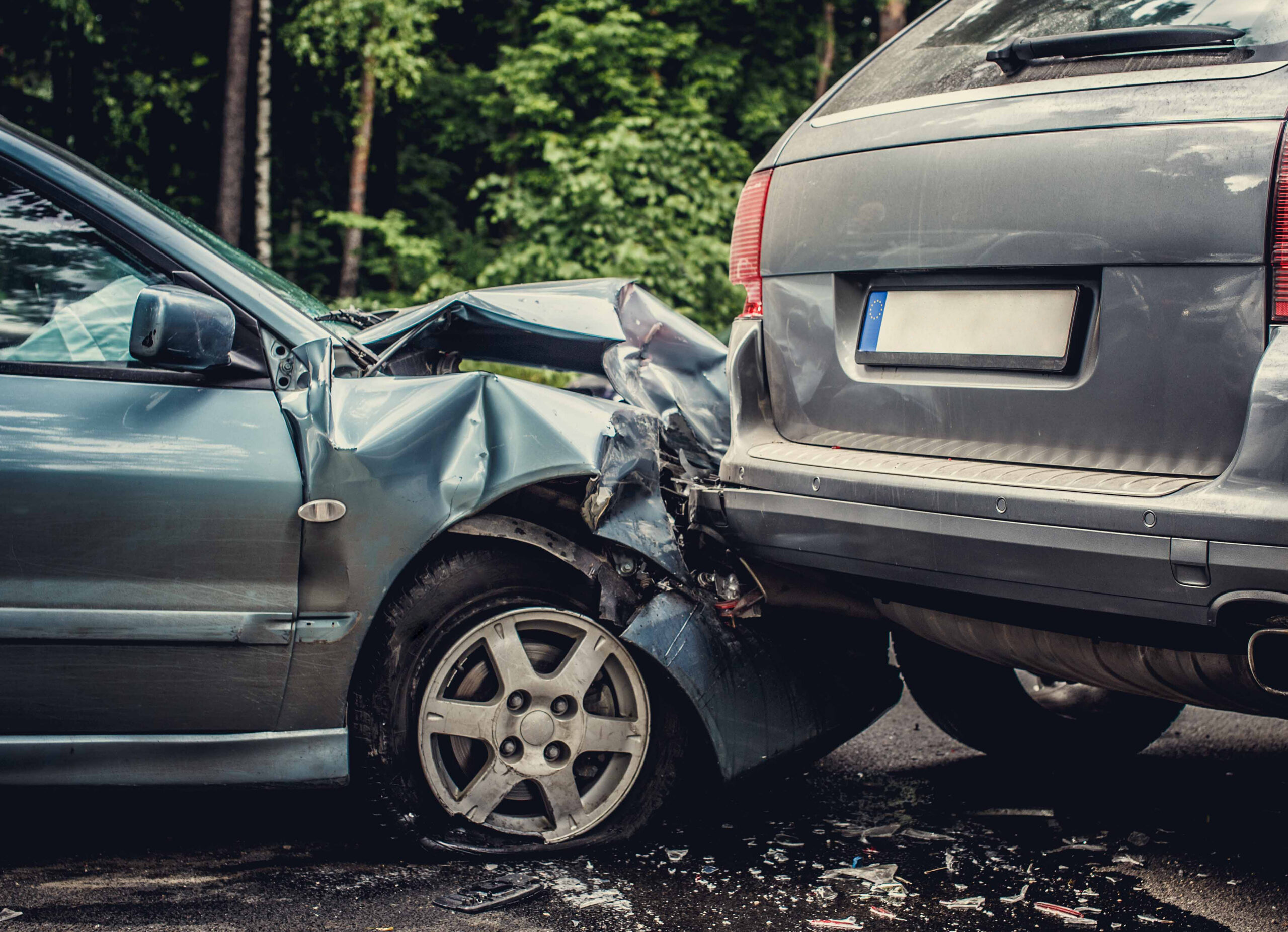 Close up smashed cars on a road.